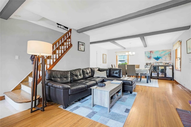 4911 168th St, Flushing, NY 11365 - living room with stairway, light wood finished floors, a chandelier, and beamed ceiling