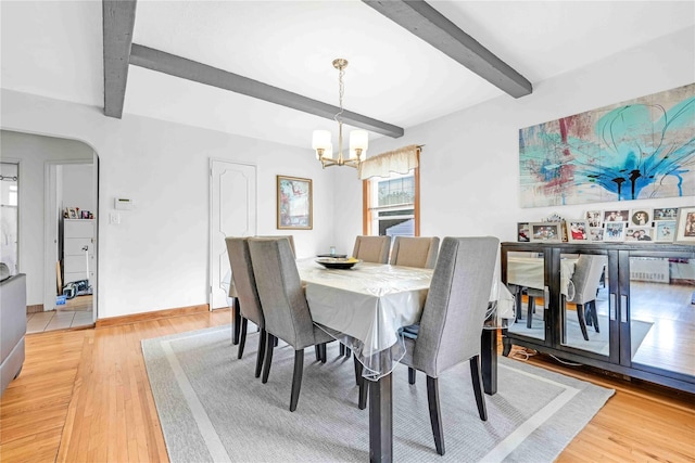 4911 168th St, Flushing, NY 11365 - dining room featuring beam ceiling, a chandelier, light wood-style flooring, and arched walkways