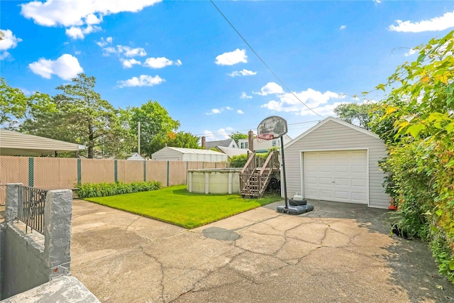 4911 168th St, Flushing, NY 11365 - view of patio / terrace featuring asphalt driveway, a garage, and an outbuilding