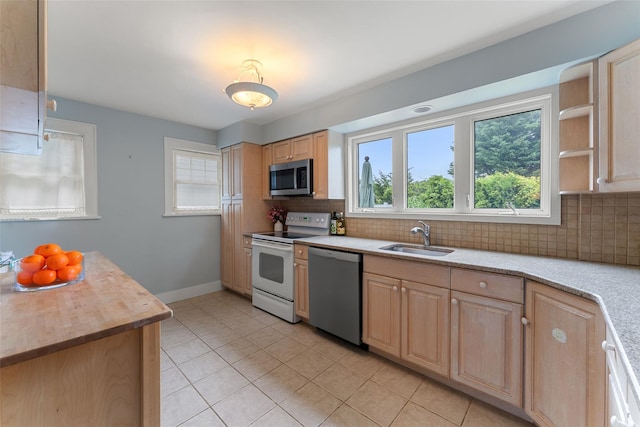 1408 Shelbourne Ave, Mamaroneck, NY 10543 - kitchen featuring stainless steel appliances, light brown cabinets, light tile patterned flooring, and tasteful backsplash