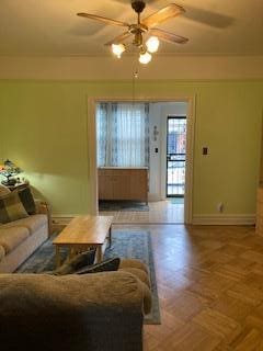 5855 41st Dr, Woodside, NY 11377 - living room with ceiling fan and baseboards