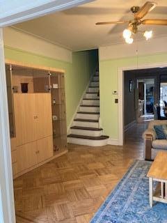 5855 41st Dr, Woodside, NY 11377 - living area with stairs and a ceiling fan