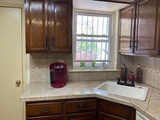 5855 41st Dr, Woodside, NY 11377 - kitchen with light countertops, dark brown cabinetry, and decorative backsplash