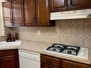 5855 41st Dr, Woodside, NY 11377 - kitchen featuring white appliances, light countertops, under cabinet range hood, dark brown cabinets, and decorative backsplash
