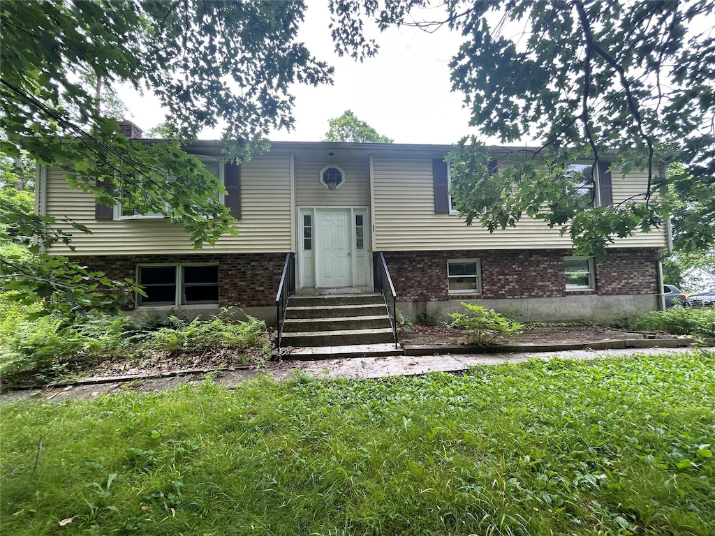 421 Rte 164, Brewster, NY 12563 - raised ranch featuring entry steps, a front yard, and brick siding