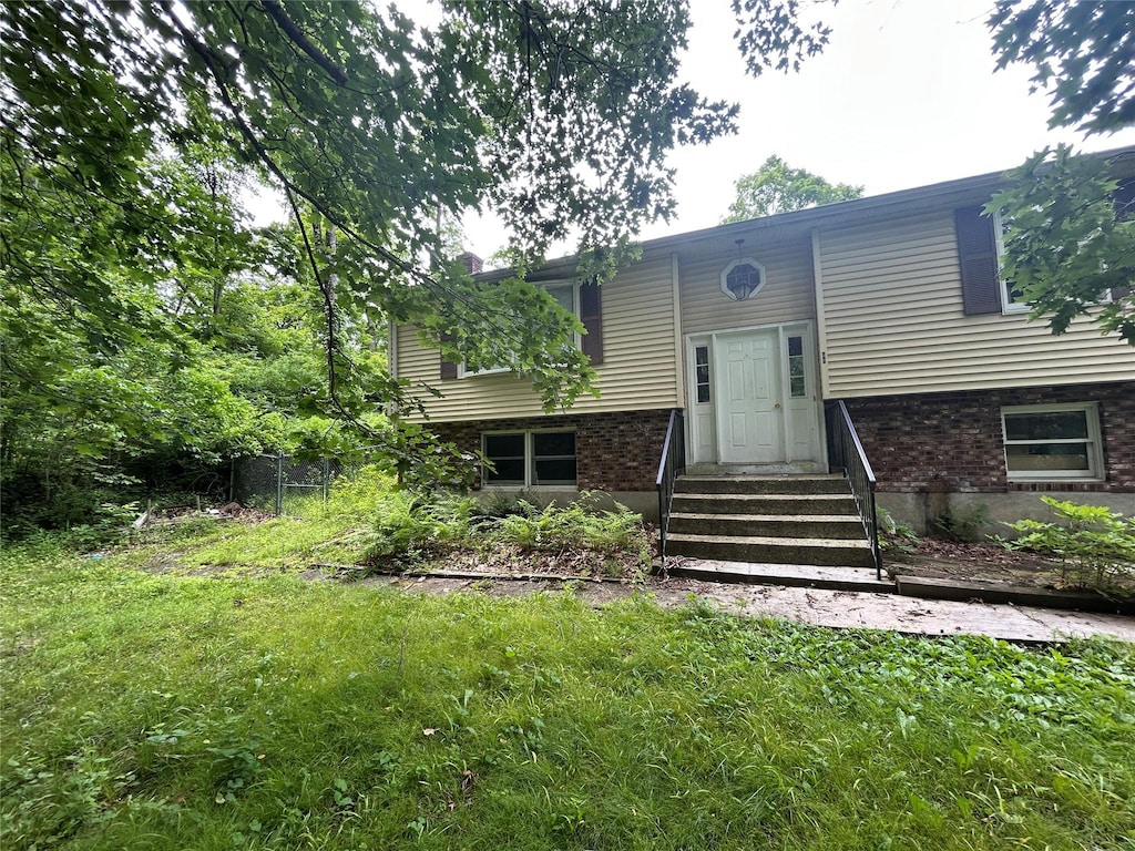 421 Rte 164, Brewster, NY 12563 - view of front of house with entry steps, brick siding, and a front yard
