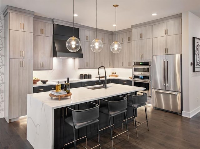 4039 Fairways Dr Unit 120, Carmel, NY 10512 - kitchen featuring appliances with stainless steel finishes, dark wood-style floors, exhaust hood, a kitchen bar, and an island with sink