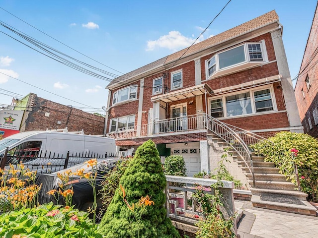 1405 E 233rd St, Bronx, NY 10466 - view of front facade with brick siding and a garage