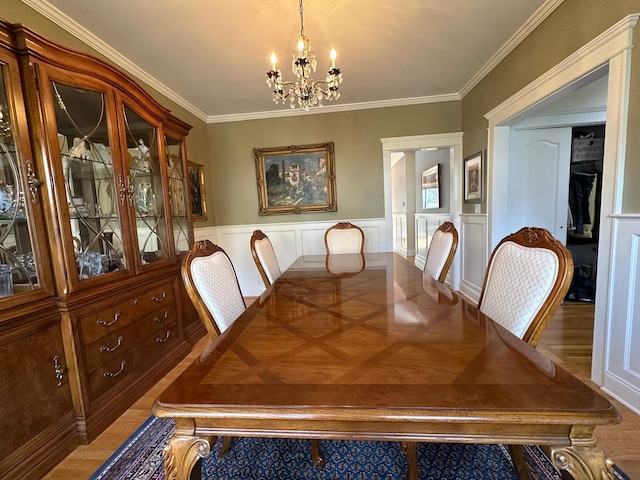 133 Woodbrook Rd, White Plains, NY 10605 - dining space with a chandelier, ornamental molding, wainscoting, and a decorative wall