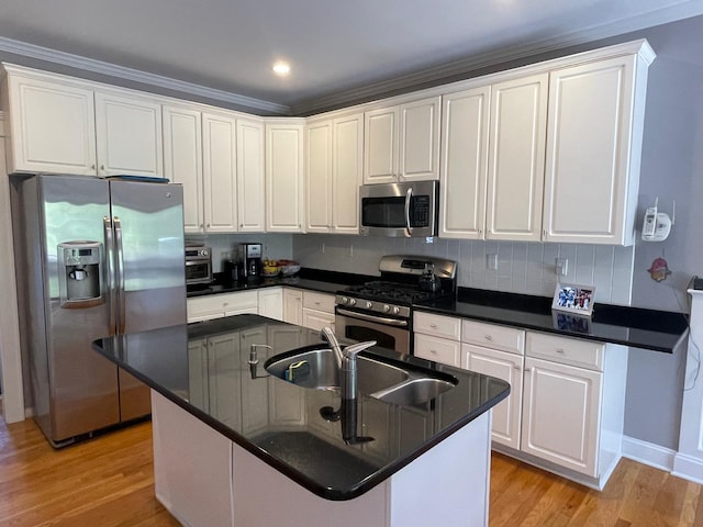 133 Woodbrook Rd, White Plains, NY 10605 - kitchen with appliances with stainless steel finishes, light wood-style floors, white cabinets, dark countertops, and ornamental molding
