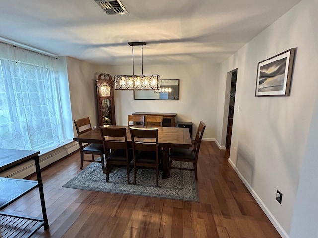 43 Southfield Rd, Baiting Hollow, NY 11933 - dining room featuring a chandelier, dark wood finished floors, and a baseboard radiator