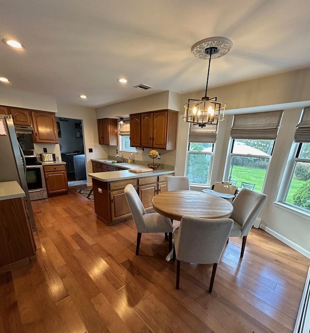 43 Southfield Rd, Baiting Hollow, NY 11933 - dining room with a chandelier, wood finished floors, and recessed lighting