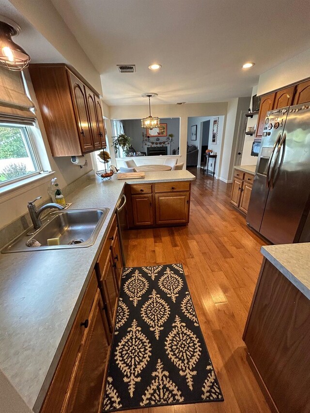 43 Southfield Rd, Baiting Hollow, NY 11933 - kitchen featuring stainless steel appliances, a peninsula, light wood-style floors, light countertops, and a chandelier