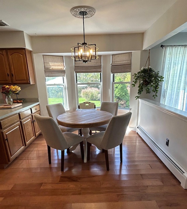 43 Southfield Rd, Baiting Hollow, NY 11933 - dining room featuring baseboard heating, a chandelier, and light wood-style flooring