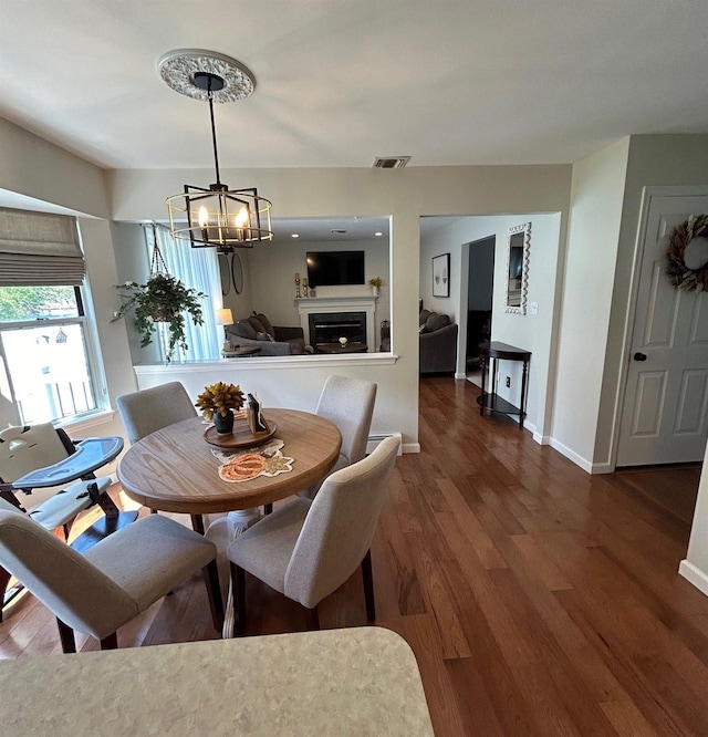 43 Southfield Rd, Baiting Hollow, NY 11933 - dining room with a chandelier, wood finished floors, and a fireplace