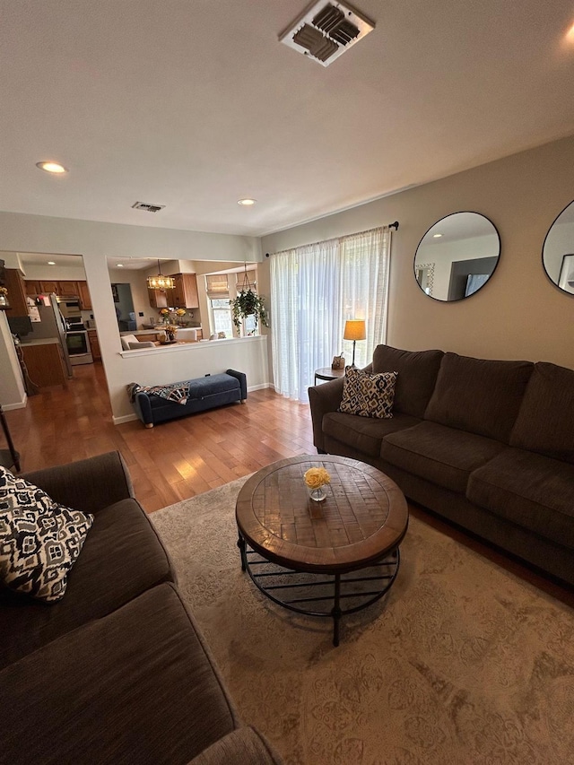 43 Southfield Rd, Baiting Hollow, NY 11933 - living area featuring a chandelier, wood finished floors, and recessed lighting
