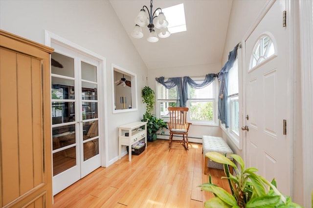 25 December Walk, Long Beach, NY 11561 - sunroom with french doors, vaulted ceiling, a baseboard heating unit, a chandelier, and a skylight