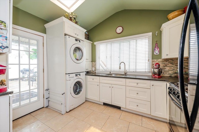 25 December Walk, Long Beach, NY 11561 - laundry room featuring stacked washing machine and dryer, plenty of natural light, and light tile patterned floors
