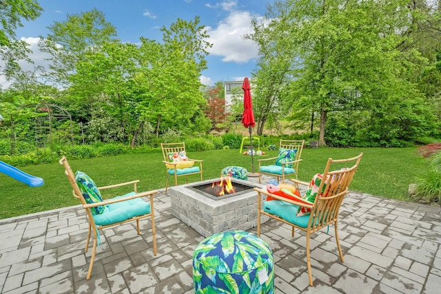 31 Pierce Dr, Pleasantville, NY 10570 - view of patio / terrace with a fire pit, view of wooded area, and a playground