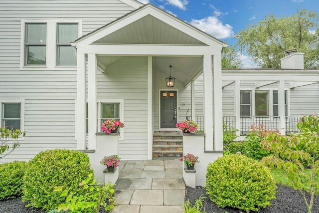 31 Pierce Dr, Pleasantville, NY 10570 - view of exterior entry featuring a chimney and covered porch