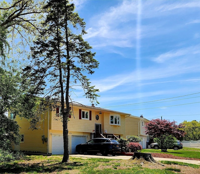 373 Commack Rd, Islip, NY 11751 - bi-level home with an attached garage and concrete driveway