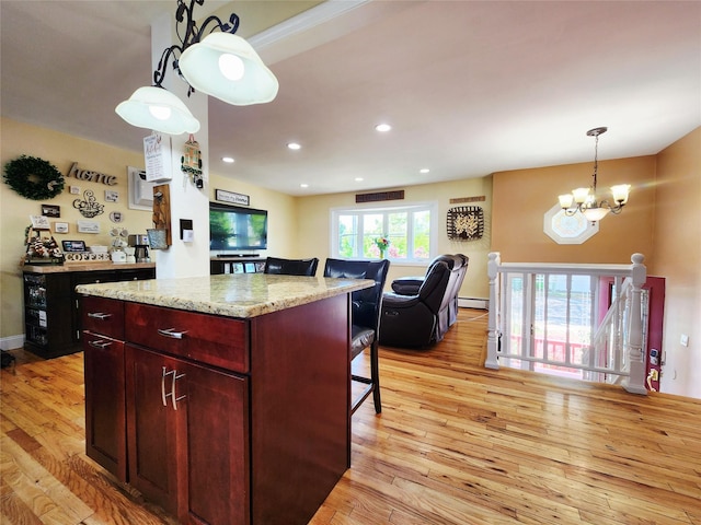 373 Commack Rd, Islip, NY 11751 - kitchen with a chandelier, light wood-style flooring, a baseboard heating unit, hanging light fixtures, and a kitchen island
