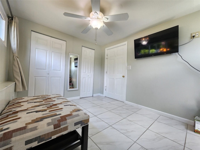 373 Commack Rd, Islip, NY 11751 - bedroom with multiple closets, light tile patterned floors, and ceiling fan