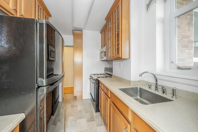 5355 Henry Hudson Pkwy W Unit 5C, Bronx, NY 10471 - kitchen with freestanding refrigerator, gas stove, stainless steel microwave, brown cabinets, and glass insert cabinets