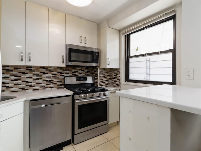 61-25 98th St Unit 2H, Rego Park, NY 11374 - kitchen featuring appliances with stainless steel finishes, light countertops, backsplash, and light tile patterned floors