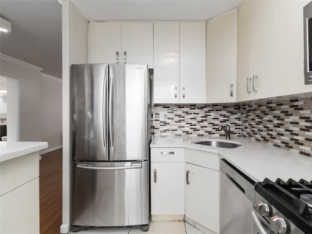 61-25 98th St Unit 2H, Rego Park, NY 11374 - kitchen featuring appliances with stainless steel finishes, light countertops, crown molding, backsplash, and light wood-style floors