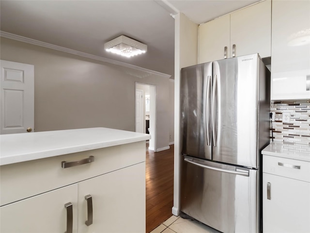 61-25 98th St Unit 2H, Rego Park, NY 11374 - kitchen featuring freestanding refrigerator, ornamental molding, light countertops, and light tile patterned floors