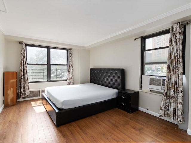 61-25 98th St Unit 2H, Rego Park, NY 11374 - bedroom featuring wood finished floors, ornamental molding, and cooling unit