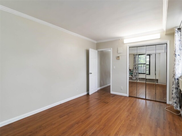 61-25 98th St Unit 2H, Rego Park, NY 11374 - unfurnished bedroom featuring crown molding, wood finished floors, and a closet