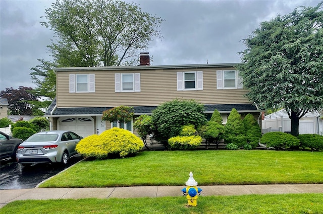 23 Crown Ln, Westbury, NY 11590 - view of front of property featuring a chimney, driveway, a front yard, a garage, and roof with shingles