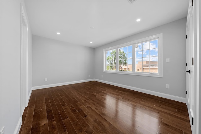 71 Cedar St, Hicksville, NY 11801 - empty room with dark wood-style flooring and recessed lighting