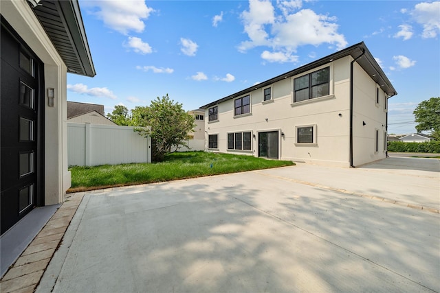 71 Cedar St, Hicksville, NY 11801 - rear view of house featuring a patio and stucco siding