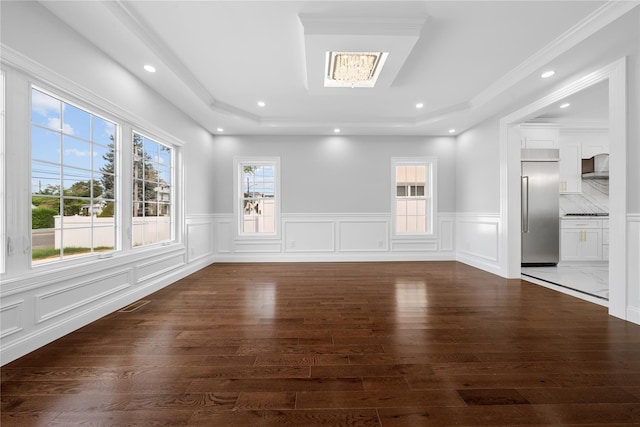 71 Cedar St, Hicksville, NY 11801 - spare room with a raised ceiling, healthy amount of natural light, dark wood-style flooring, a decorative wall, and a wainscoted wall