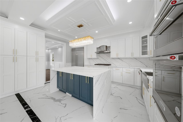 71 Cedar St, Hicksville, NY 11801 - kitchen with wall chimney range hood, blue cabinetry, stainless steel appliances, white cabinetry, and recessed lighting