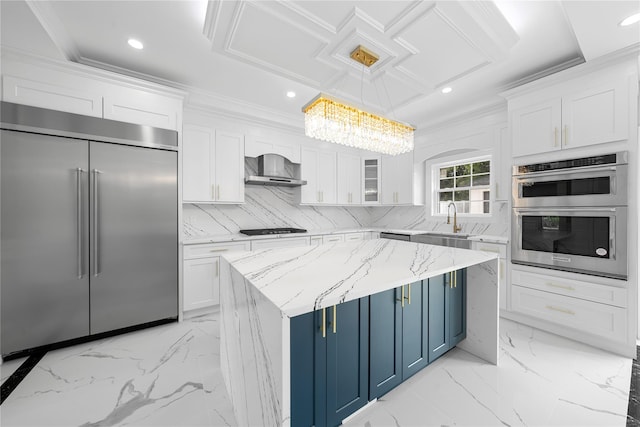 71 Cedar St, Hicksville, NY 11801 - kitchen featuring stainless steel appliances, blue cabinets, white cabinetry, wall chimney range hood, and decorative backsplash