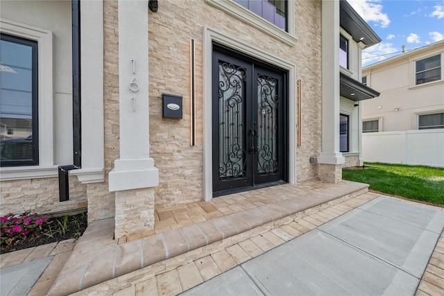 71 Cedar St, Hicksville, NY 11801 - view of exterior entry featuring french doors and stone siding
