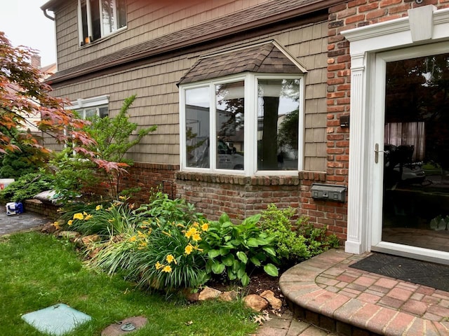 99 Stone Ln, Levittown, NY 11756 - view of side of home featuring brick siding