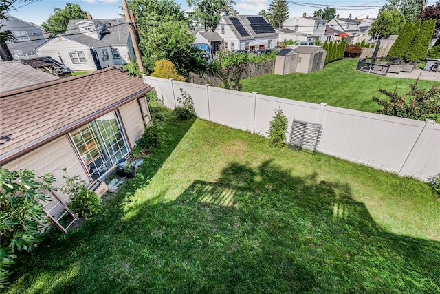 99 Stone Ln, Levittown, NY 11756 - fenced backyard featuring a shed and a residential view