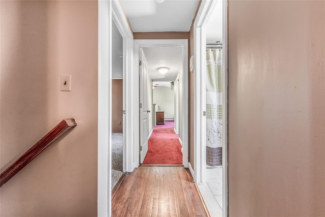 99 Stone Ln, Levittown, NY 11756 - hallway with light wood-type flooring and baseboards