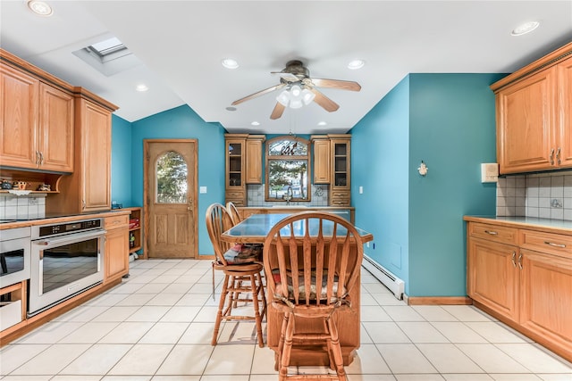 99 Stone Ln, Levittown, NY 11756 - kitchen with stainless steel oven, a baseboard heating unit, ceiling fan, decorative backsplash, and recessed lighting