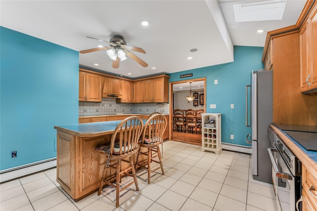 99 Stone Ln, Levittown, NY 11756 - kitchen with stainless steel appliances, a baseboard heating unit, decorative backsplash, a ceiling fan, and recessed lighting