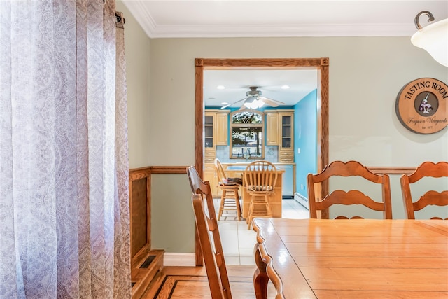 99 Stone Ln, Levittown, NY 11756 - dining space featuring a ceiling fan, ornamental molding, a baseboard heating unit, and light wood-type flooring