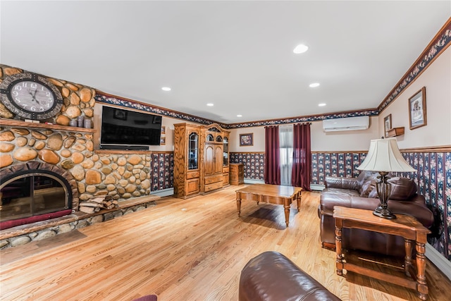 99 Stone Ln, Levittown, NY 11756 - living area featuring an AC wall unit, wainscoting, light wood finished floors, recessed lighting, and a fireplace