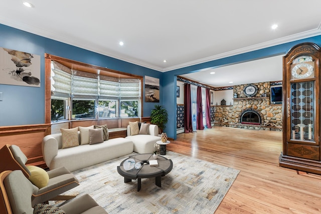 99 Stone Ln, Levittown, NY 11756 - living room with crown molding, wood finished floors, a stone fireplace, and recessed lighting