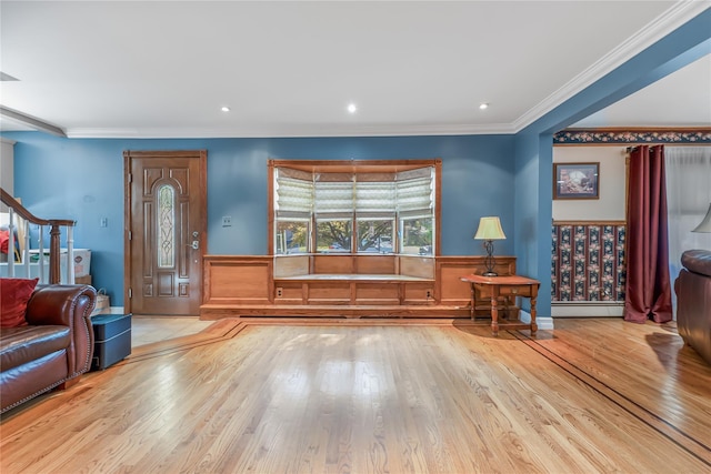 99 Stone Ln, Levittown, NY 11756 - foyer entrance with wood finished floors, ornamental molding, a baseboard radiator, wainscoting, and recessed lighting