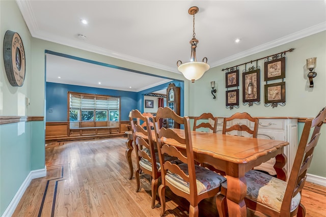 99 Stone Ln, Levittown, NY 11756 - dining room with light wood-style flooring, crown molding, and recessed lighting